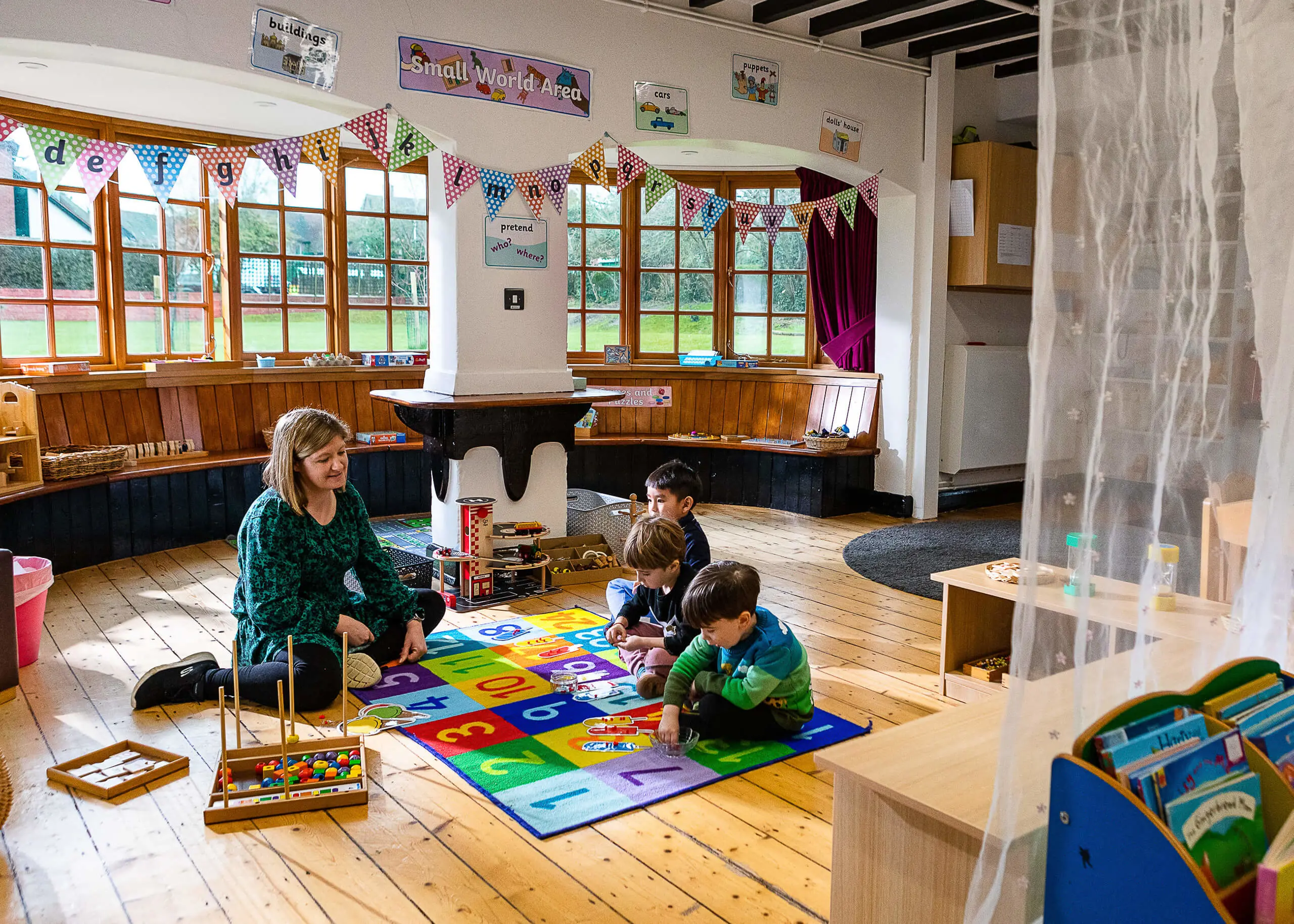 Pupil in class with nursery teacher at St Chris