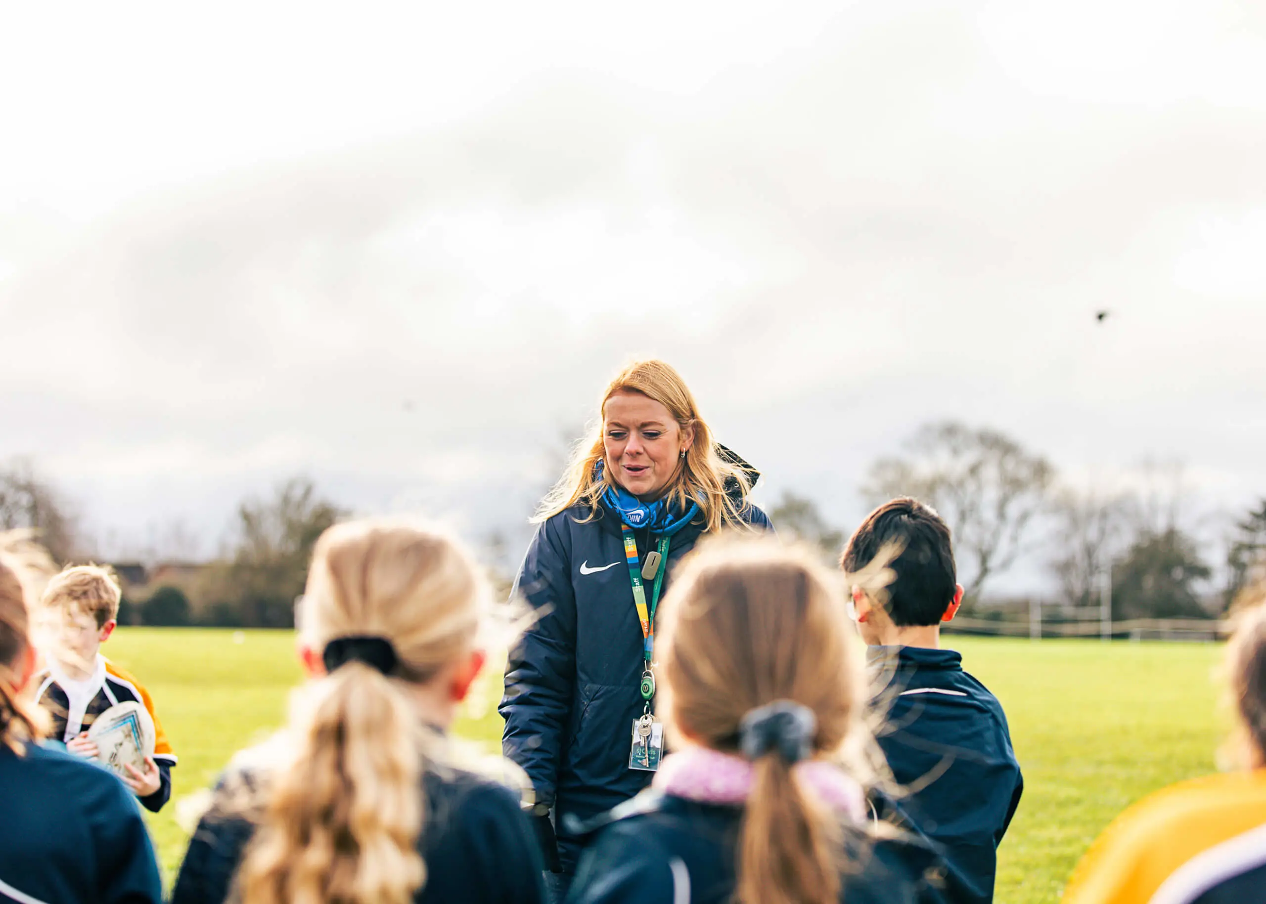 Rugby teacher with pupils at St Chris